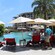 Guests relaxing around and swimming in a free form swimming pool at a resort